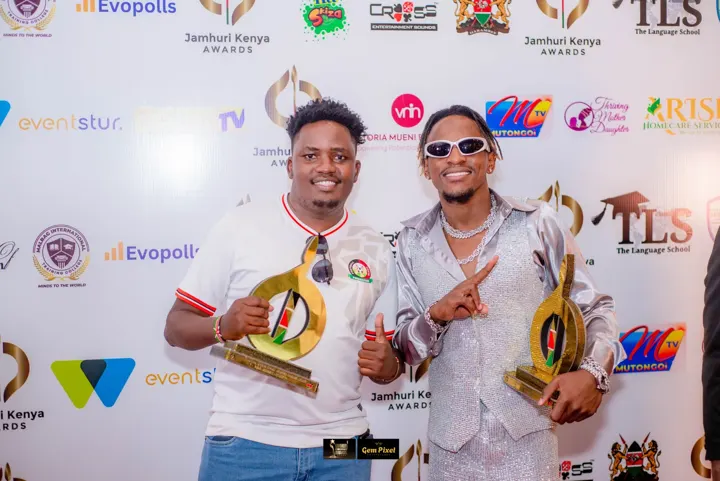 Two winners with trophies